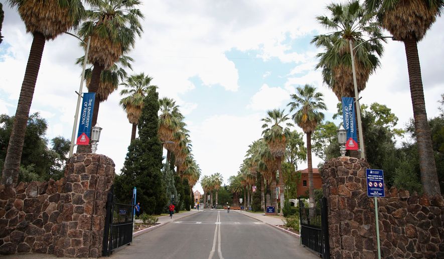 The main gate at the University of Arizona is shown, Friday, July 31, 2015, in Tucson, Ariz. (AP Photo/Ross D. Franklin)