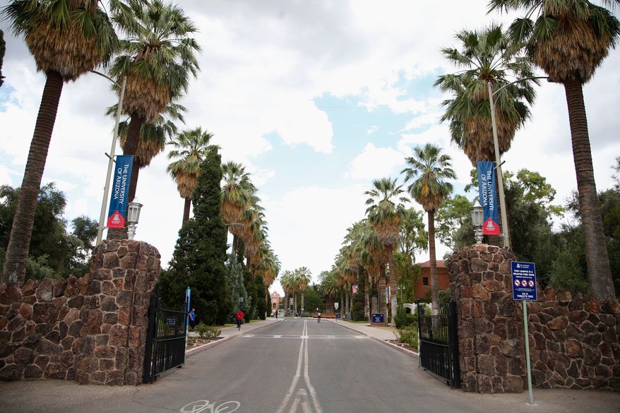 The main gate at the University of Arizona is shown, Friday, July 31, 2015, in Tucson, Ariz. (AP Photo/Ross D. Franklin)