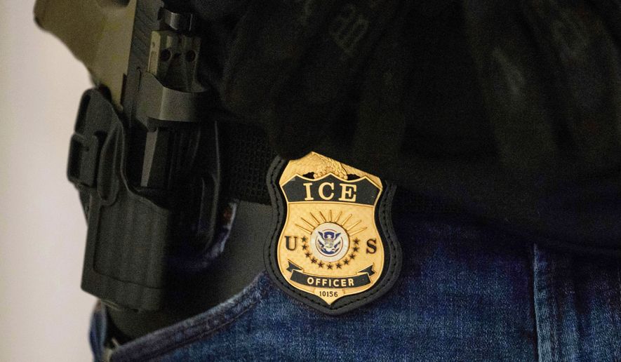 FILE - A federal agent wears an Immigration and Customs Enforcement badge at the immigration court at Jacob K. Javits Federal Building in New York, on Monday, June 9, 2025. (AP Photo/Yuki Iwamura, File)