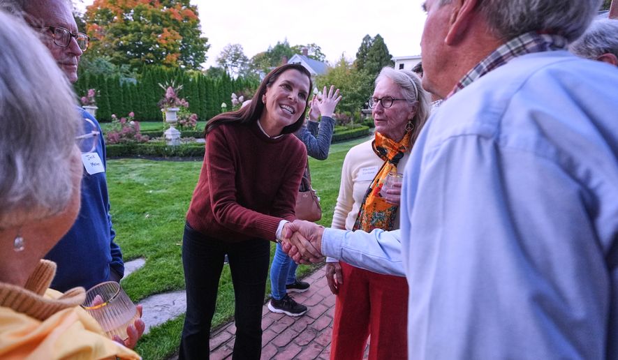 Stefany Shaheen, Democratic candidate for the U.S. House in New Hampshire's 1st Congressional District who will face Republican Anthony DiLorenzo, shakes hands with guests during a campaign stop, Wednesday, Sept. 30, 2026, in Dover, N.H. (AP Photo/Charles Krupa)