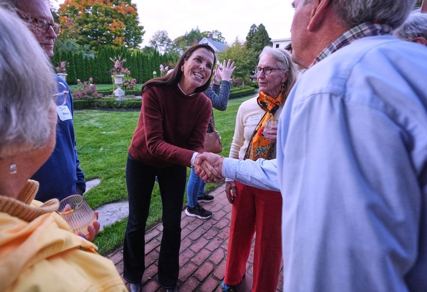 Stefany Shaheen, Democratic candidate for the U.S. House in New Hampshire's 1st Congressional District who will face Republican Anthony DiLorenzo, shakes hands with guests during a campaign stop, Wednesday, Sept. 30, 2026, in Dover, N.H. (AP Photo/Charles Krupa)