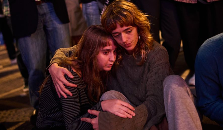 Protesters gather after the reported death of María del Carmen Abascal, the 87-year-old woman whose eviction sparked nationwide protests, in Puerta del Sol square in Madrid, Wednesday, Oct. 7, 2026. (AP Photo/Bernat Armangue)