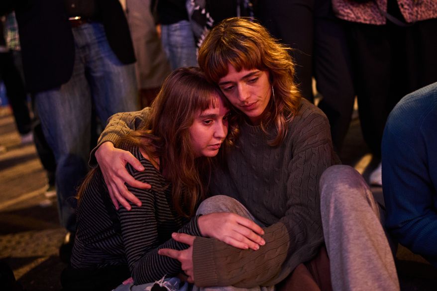 Protesters gather after the reported death of María del Carmen Abascal, the 87-year-old woman whose eviction sparked nationwide protests, in Puerta del Sol square in Madrid, Wednesday, Oct. 7, 2026. (AP Photo/Bernat Armangue)