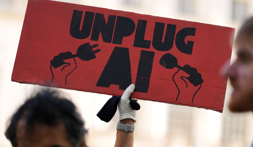 A small group of people supporting restrictions on artificial intelligence hold up signs in front of City Hall before a New York City Council hearing on artificial intelligence safety in New York on Oct. 5, 2026. (AP Photo/Seth Wenig) **FILE**
