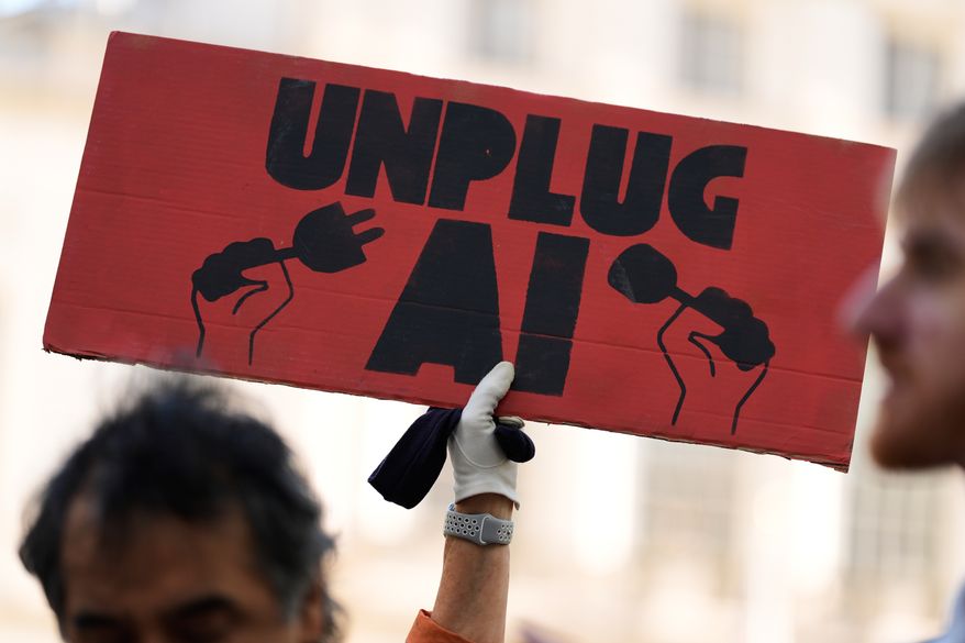 A small group of people supporting restrictions on artificial intelligence hold up signs in front of City Hall before a New York City Council hearing on artificial intelligence safety in New York on Oct. 5, 2026. (AP Photo/Seth Wenig) **FILE**
