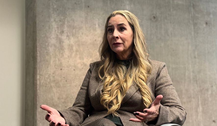 This photo made with a smartphone shows Bernadette Greene-Placentia, who is running for congress in Arizona's 8th Congressional District speaking during an interview with The Associated Press in Phoenix, Thursday, Oct. 8, 2026. (AP Photo/Wufei Yu)