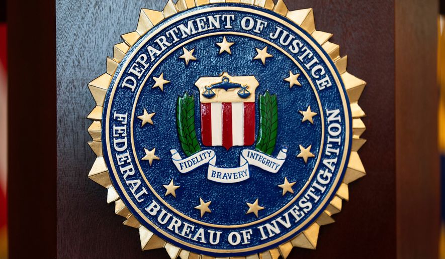 FILE - An FBI seal is displayed on a podium before a news conference at the field office in Portland, Ore., Jan. 16, 2025. (AP Photo/Jenny Kane, File)
