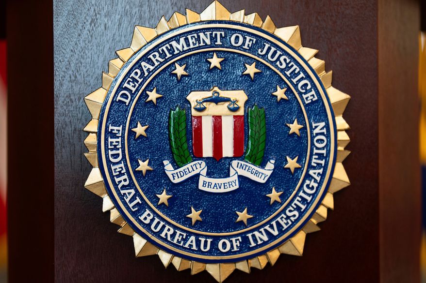 FILE - An FBI seal is displayed on a podium before a news conference at the field office in Portland, Ore., Jan. 16, 2025. (AP Photo/Jenny Kane, File)