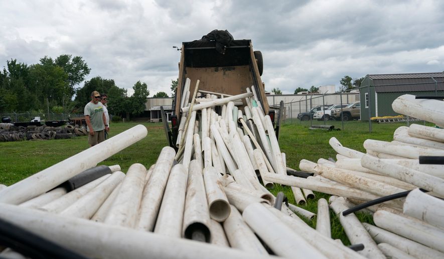 IPEX PVC pipe cleared from the riverbank is dumped at MountainTrue headquarters Wednesday, July 22, 2026, in Alexander, N.C. (AP Photo/Allison Joyce)