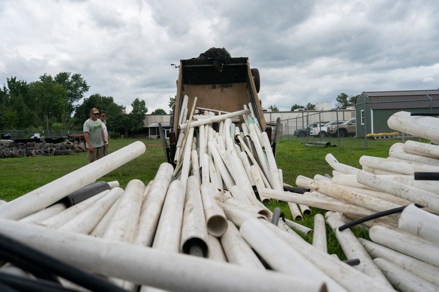 IPEX PVC pipe cleared from the riverbank is dumped at MountainTrue headquarters Wednesday, July 22, 2026, in Alexander, N.C. (AP Photo/Allison Joyce)
