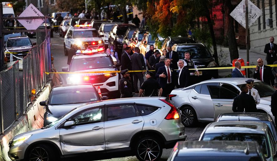 Law enforcement work the scene of a shooting Thursday, Oct. 8, 2026, in New York. (AP Photo/Seth Wenig)