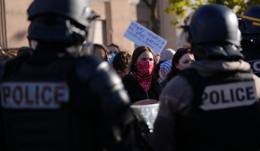 Students face police officers in front of the Helene Boucher high School during a protest against under-resourced schools, in Paris, Thursday Oct. 8, 2026. (AP Photo/Aurelien Morissard)