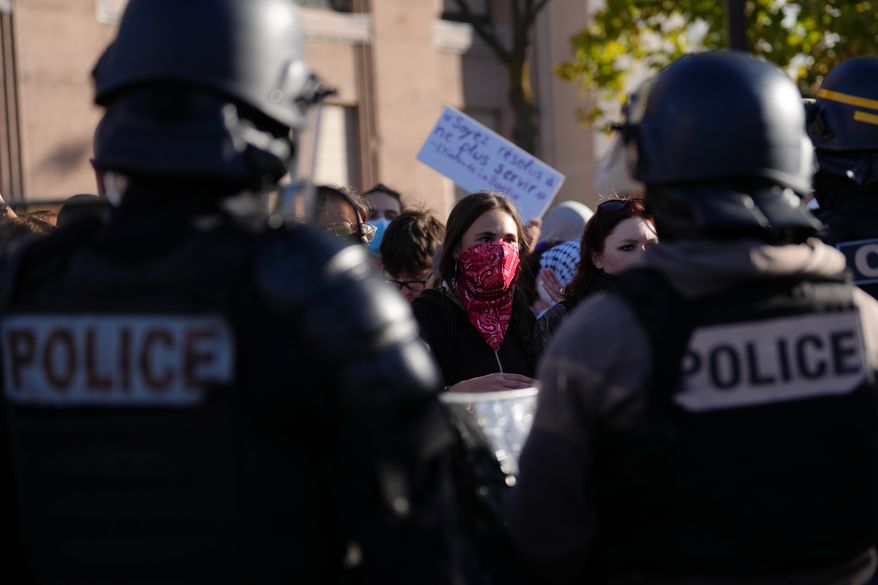 Students face police officers in front of the Helene Boucher high School during a protest against under-resourced schools, in Paris, Thursday Oct. 8, 2026. (AP Photo/Aurelien Morissard)