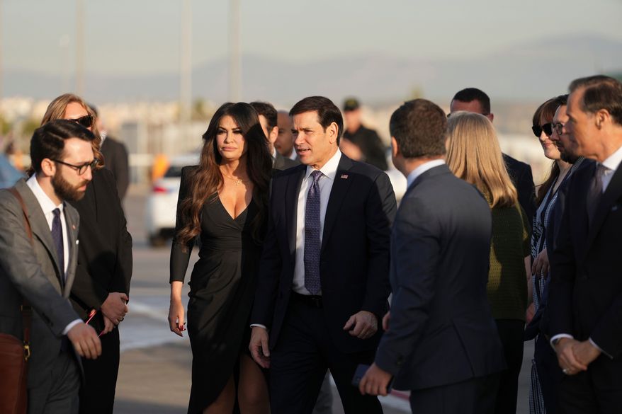 U.S. Secretary of State Marco Rubio, center, and U.S. Ambassador to Greece Kimberly Guilfoyle stand at Eleftherios Venizelos International Airport near Athens, Greece, before Rubio boards a plane , Thursday, Oct. 8, 2026. (AP Photo/Mark Schiefelbein, Pool)