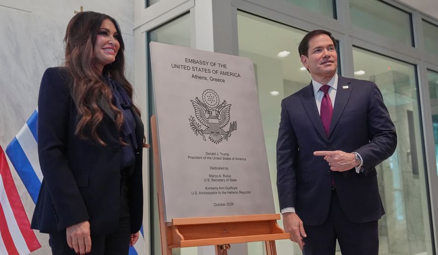 U.S. Secretary of State Marco Rubio right, and U.S. Ambassador to Greece Kimberly Guilfoyle unveil a plaque during a dedication ceremony at the chancery of the U.S. Embassy, Wednesday, Oct. 7, 2026, in Athens, Greece. (AP Photo/Mark Schiefelbein, Pool)