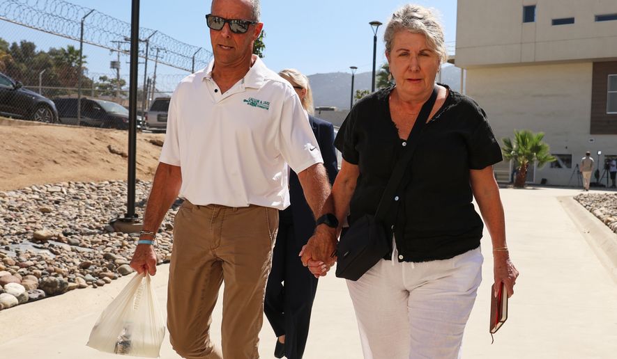 Debra and Martin Robinson, the parents of Australian brothers Callum and Jake Robinson, arrive to court for the trial of the men accused of murdering them, in Ensenada, Mexico, Thursday, Oct. 8, 2026. (AP Photo/Karen Castaneda)