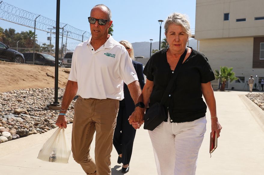 Debra and Martin Robinson, the parents of Australian brothers Callum and Jake Robinson, arrive to court for the trial of the men accused of murdering them, in Ensenada, Mexico, Thursday, Oct. 8, 2026. (AP Photo/Karen Castaneda)