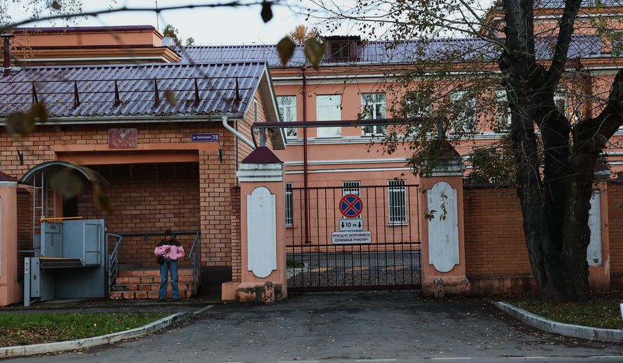 A pedestrian stands at the building of the Irkutsk Anti-Plague Research Institute of Siberia and the Far East in Irkutsk, Russi, on Wednesday, Oct. 7, 2026. (AP Photo)