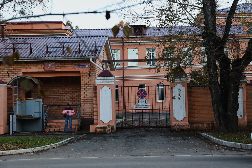 A pedestrian stands at the building of the Irkutsk Anti-Plague Research Institute of Siberia and the Far East in Irkutsk, Russi, on Wednesday, Oct. 7, 2026. (AP Photo)