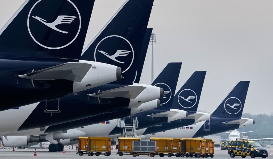 Lufthansa aircraft are parked at an airport in Munich, Germany, April 13, 2026. (AP Photo/Matthias Schrader, File)