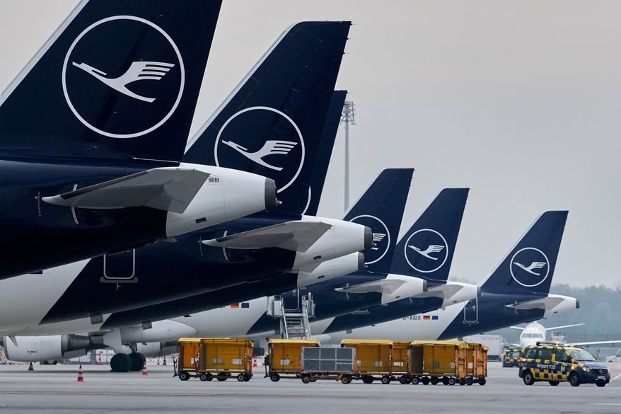 Lufthansa aircraft are parked at an airport in Munich, Germany, April 13, 2026. (AP Photo/Matthias Schrader, File)