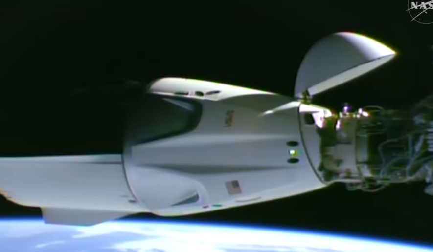 This image taken from video by NASA shows a SpaceX capsule carrying four astronauts docking at the International Space Station, Thursday, Oct. 1, 2026. (NASA via AP)