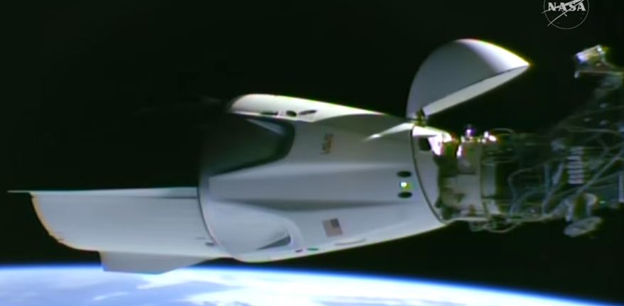 This image taken from video by NASA shows a SpaceX capsule carrying four astronauts docking at the International Space Station, Thursday, Oct. 1, 2026. (NASA via AP)