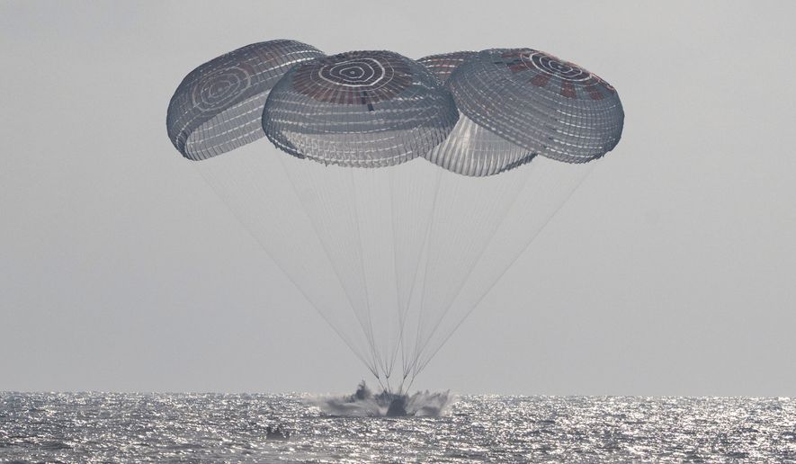 In this photo provided by NASA, the SpaceX Crew Dragon Freedom spacecraft splashes down in the Pacific Ocean off the coast of California on Thursday, Oct. 8, 2026, returning from the International Space Station. (Keegan Barber/NASA via AP)