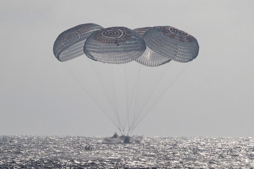 In this photo provided by NASA, the SpaceX Crew Dragon Freedom spacecraft splashes down in the Pacific Ocean off the coast of California on Thursday, Oct. 8, 2026, returning from the International Space Station. (Keegan Barber/NASA via AP)