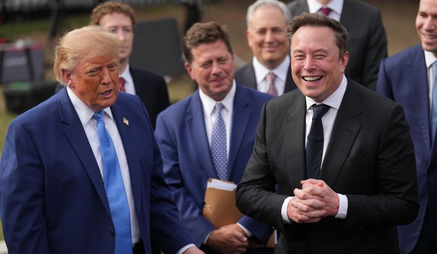 President Donald Trump listens as Elon Musk speaks to reporters at the White House in Washington, Tuesday Sept. 29, 2026, after meeting with top executives of AI firms. (AP Photo/Jacquelyn Martin)