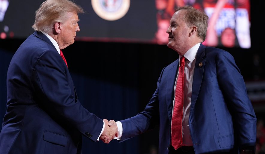 President Donald Trump greets Republican U.S. Senate candidate Texas Attorney General Ken Paxton at a campaign rally at the Freeman Coliseum in San Antonio, Wednesday, Oct. 7, 2026. (AP Photo/Alex Brandon)