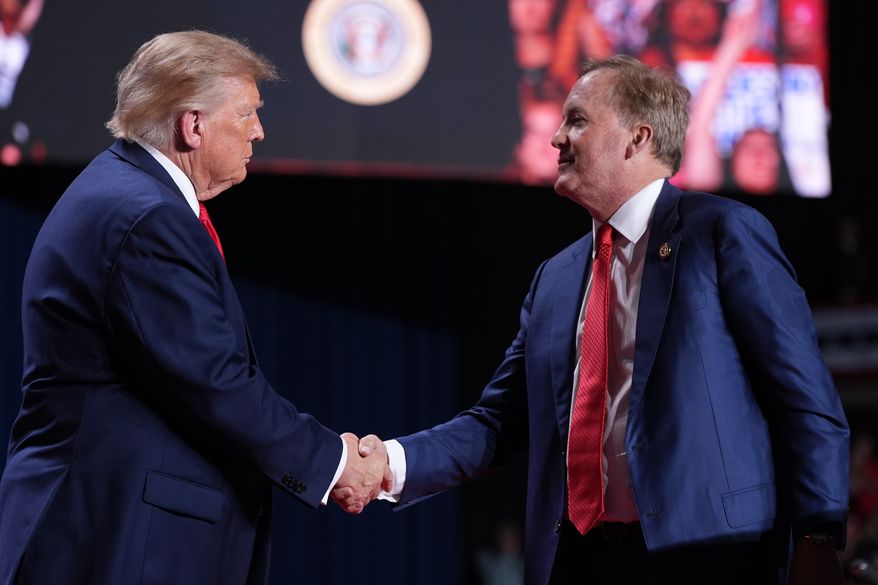 President Donald Trump greets Republican U.S. Senate candidate Texas Attorney General Ken Paxton at a campaign rally at the Freeman Coliseum in San Antonio, Wednesday, Oct. 7, 2026. (AP Photo/Alex Brandon)