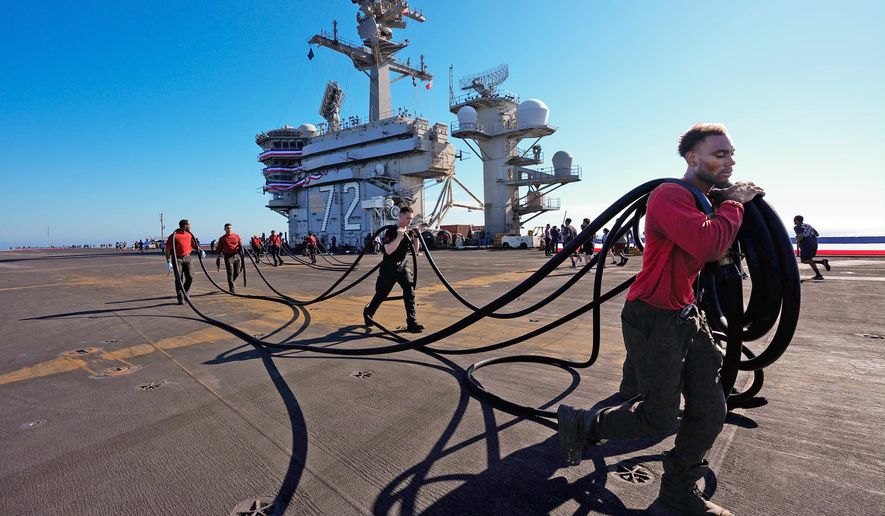 Crew members prepare the U.S.S. Abraham Lincoln (CVN 72) for return on Wednesday, Oct. 7, 2026, to her home port Naval Air Station North Island in San Diego, Calif. (Nelvin C. Cepeda/The San Diego Union-Tribune via AP)