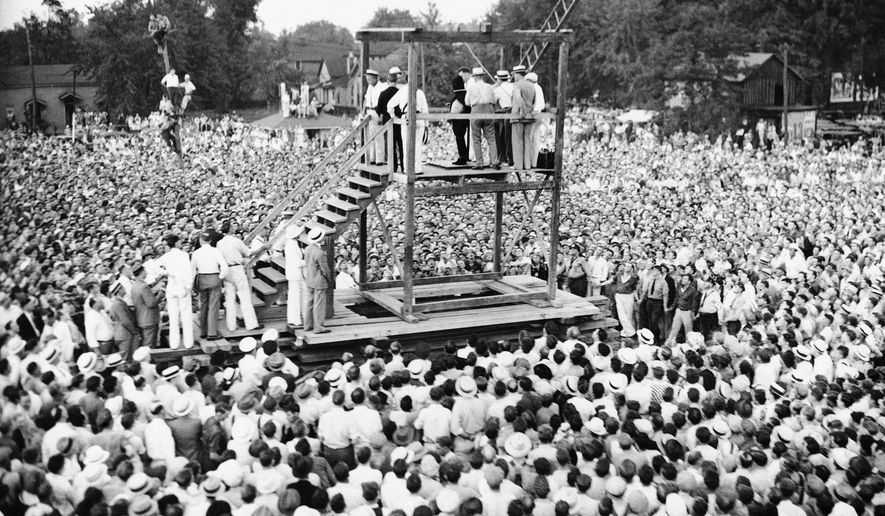 In this Friday, Aug. 14, 1936 file picture, a large crowd watches as attendants adjust a black hood over Rainey Bethea's head just before his public hanging in Owensboro, Ky. Bethea, a 22-year-old black man convicted of raping a 70-year-old white woman, was the last person killed in a public execution in the United States. America's executions have changed dramatically over the years, morphing from day-long events in the town square to somber and tightly controlled affairs held deep inside prisons. (AP File Photo)