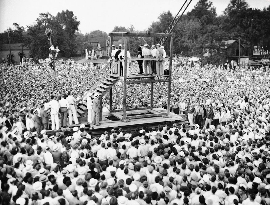 In this Friday, Aug. 14, 1936 file picture, a large crowd watches as attendants adjust a black hood over Rainey Bethea's head just before his public hanging in Owensboro, Ky. Bethea, a 22-year-old black man convicted of raping a 70-year-old white woman, was the last person killed in a public execution in the United States. America's executions have changed dramatically over the years, morphing from day-long events in the town square to somber and tightly controlled affairs held deep inside prisons. (AP File Photo)