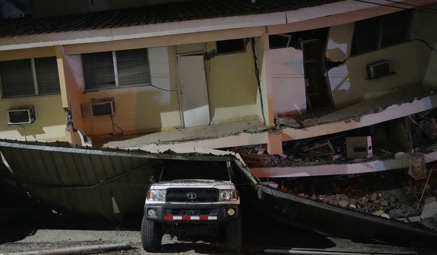 A vehicle lies crushed beneath a collapsed building after an earthquake struck Penonome, Panama, Friday, Oct. 9, 2026. (AP Photo/Aris Mariota)