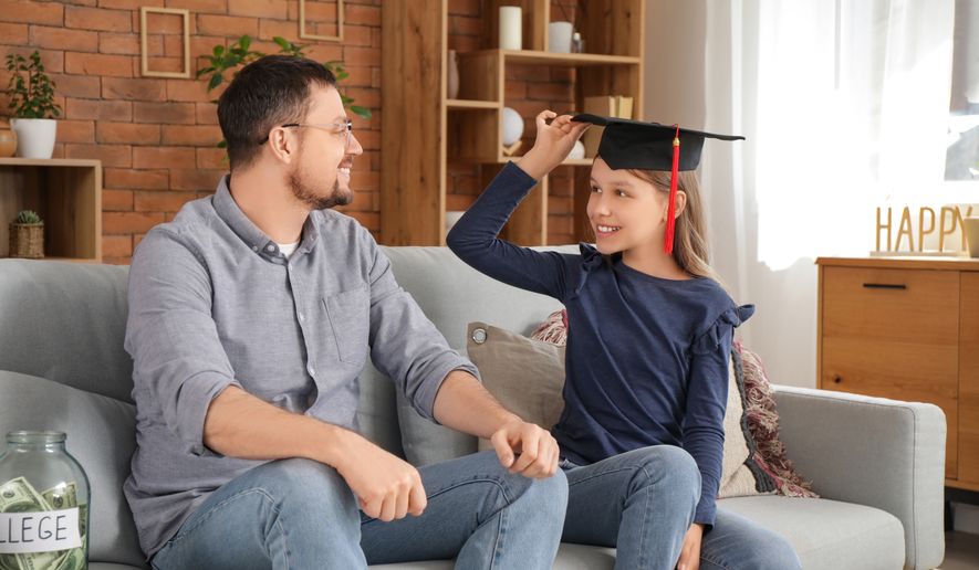FILE photo of young girl wearing a college mortarboard. (Photo by Pixel-Shot on Shutterstock)