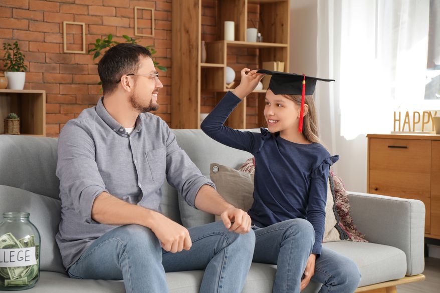 FILE photo of young girl wearing a college mortarboard. (Photo by Pixel-Shot on Shutterstock)