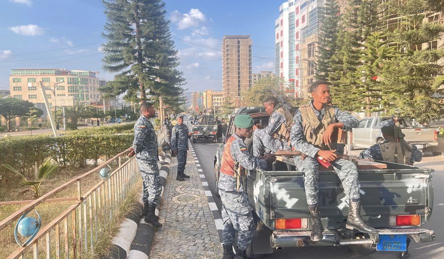 In this photo taken with a smartphone, Ethiopian federal police officers gather on a road in Mekelle, Tigray Region, Ethiopia, Thursday, Oct. 8, 2026. (AP Photo/Filmon Equar Hailu)