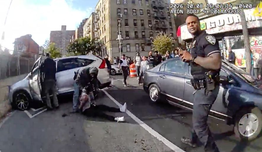In this image taken from police-worn body camera video released by the New York City Police Department (NYPD), law enforcement personnel tend to Oscar Belgal, 28, a Dominican man who was shot by federal immigration officers on Thursday, Oct. 8, 2026, in New York, as he drove his car with a 5-year-old boy inside. (NYPD via AP) ** FILE **