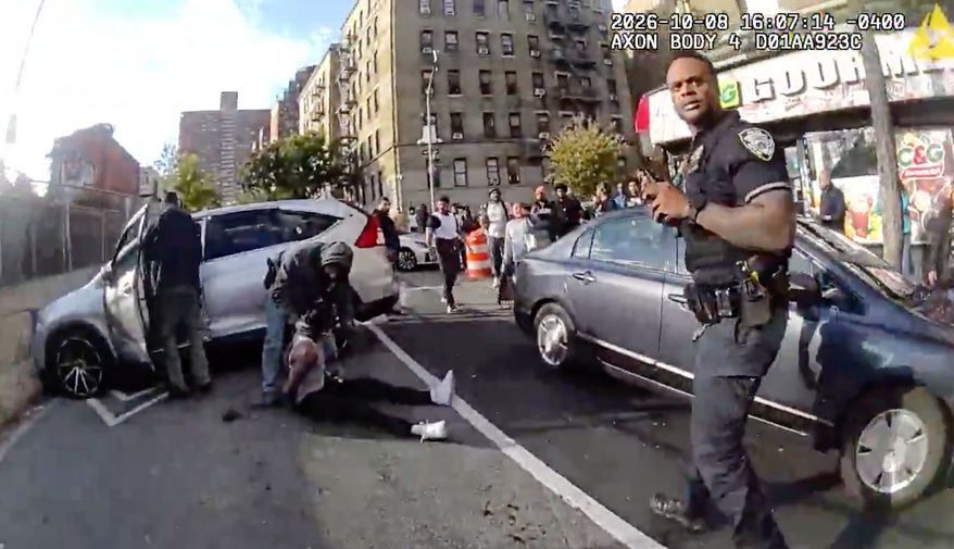 In this image taken from police-worn body camera video released by the New York City Police Department (NYPD), law enforcement personnel tend to Oscar Belgal, 28, a Dominican man who was shot by federal immigration officers on Thursday, Oct. 8, 2026, in New York, as he drove his car with a 5-year-old boy inside. (NYPD via AP) ** FILE **
