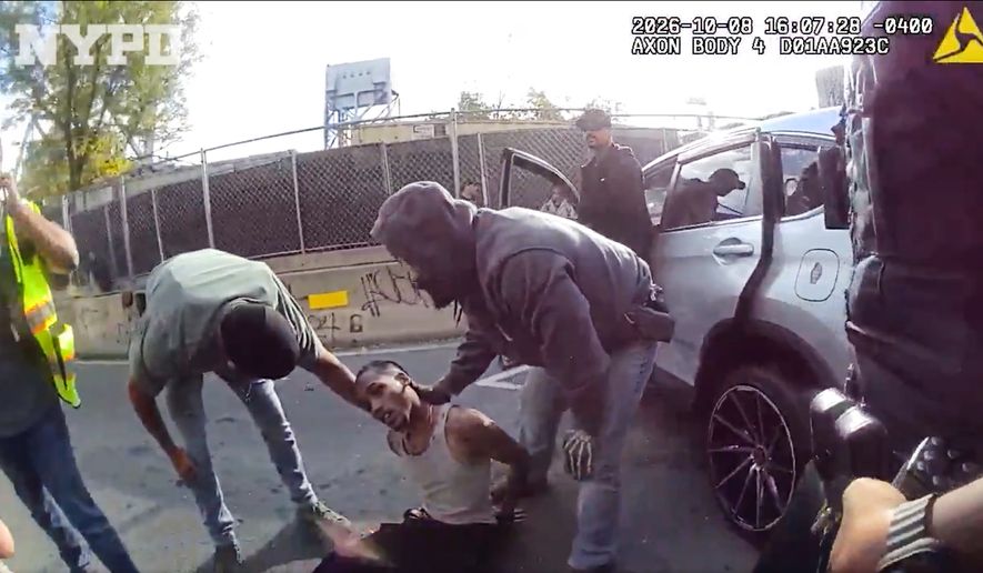 In this image taken from police-worn body camera video released the New York City Police Department (NYPD), law enforcement personnel tend to a Oscar Belgal, 28, a Dominican man who was shot by Federal immigration officers, Thursday, Oct. 8, 2026, in New York, as he drove his car with a 5-year-old boy inside. (NYPD via AP)