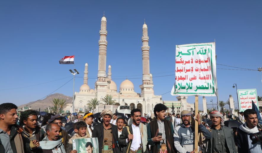 Supporters of Yemen's Houthi rebels shout slogans during a rally in support of the group, in Sanaa, Yemen, Friday, Oct. 9, 2026. Writing on posters reads in Arabic, "God is great, death to America, death to Israel, Curse the Jews, Victory to Islam." (AP Photo/Osamah Abdulrahman)