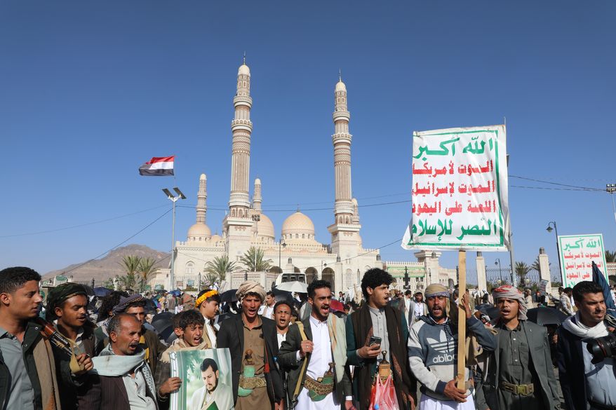 Supporters of Yemen's Houthi rebels shout slogans during a rally in support of the group, in Sanaa, Yemen, Friday, Oct. 9, 2026. Writing on posters reads in Arabic, "God is great, death to America, death to Israel, Curse the Jews, Victory to Islam." (AP Photo/Osamah Abdulrahman)
