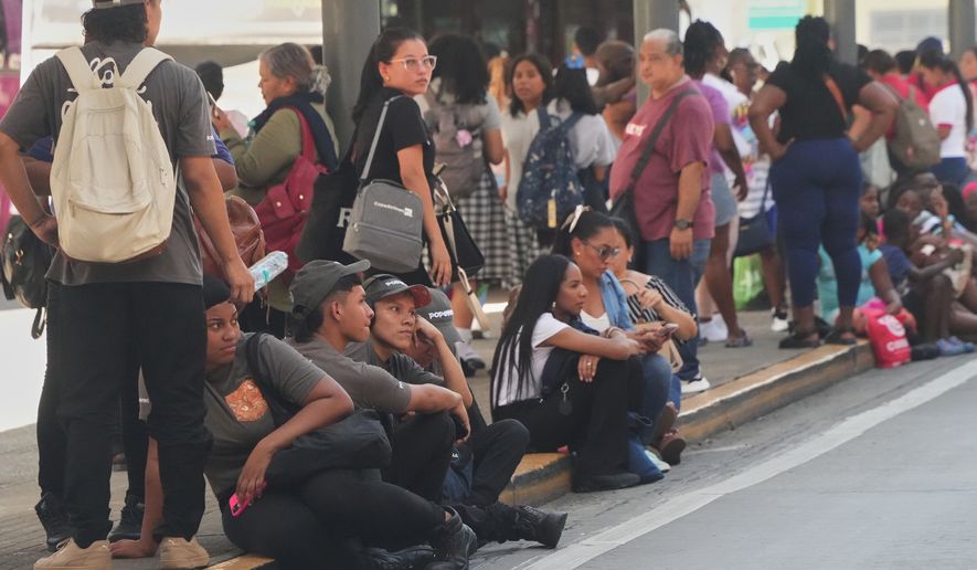 People gather outside shopping mall after an earthquake hit Panama City, Friday, Oct. 9, 2026. (AP Photo/Aris Mariota)