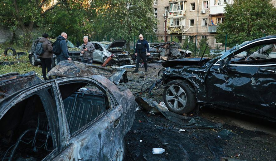Cars are seen damaged by a Russian strike on residential neighbourhood in Zaporizhzhia, Ukraine, Friday, Oct. 9, 2026. (AP Photo/Kateryna Klochko)