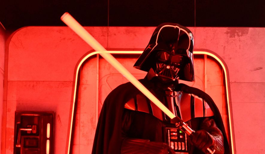 A Darth Vader-costumed character poses at the Hasbro and Amazon Star Wars interactive Imperial March experience at the Empire State Building on March 21, 2024, in New York. (Photo by Evan Agostini/Invision/AP, File)
