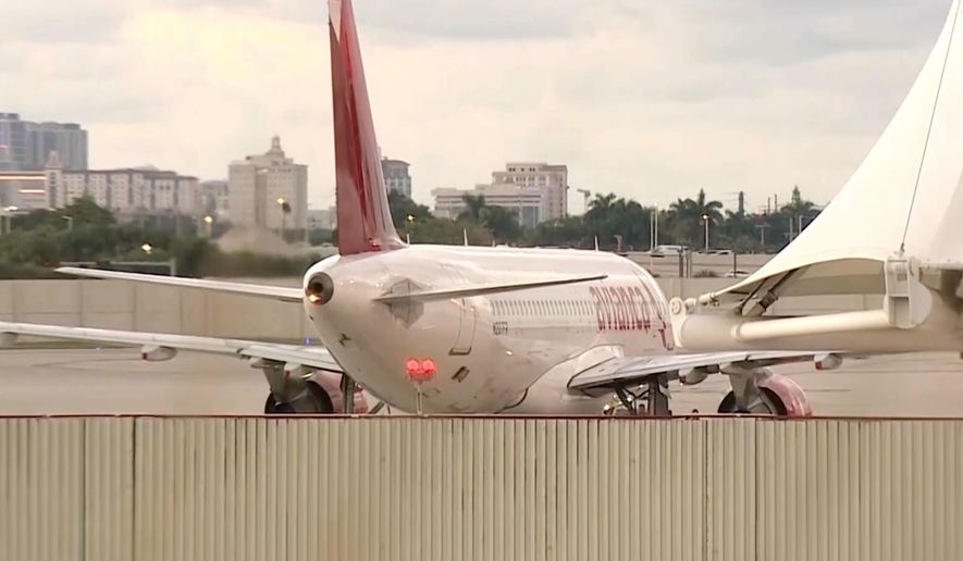 In this image from video, the Avianca Airlines plane which had encountered severe turbulence and had to make an emergency landing, is parked at Miami International Airport in Miami, on Friday, Oct. 9, 2026. (WSVN/ABC Miami via AP)