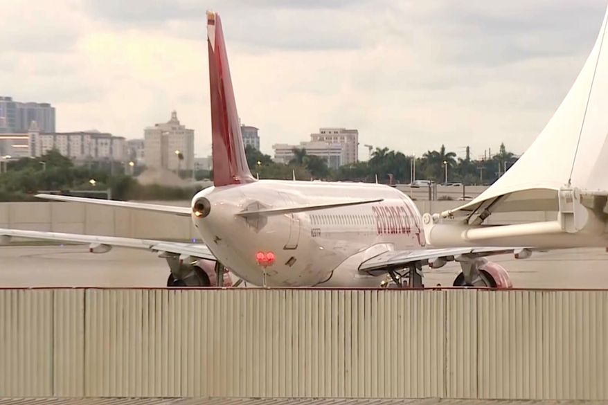 In this image from video, the Avianca Airlines plane which had encountered severe turbulence and had to make an emergency landing, is parked at Miami International Airport in Miami, on Friday, Oct. 9, 2026. (WSVN/ABC Miami via AP)