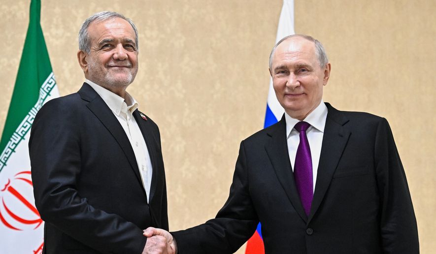 Russian President Vladimir Putin, right, and Iranian President Masoud Pezeshkian pose for a photo on the sidelines of the Commonwealth of Independent States (CIS) summit in Turkmenistan, Thursday, Oct. 8, 2026. (Sergei Bobylev, Sputnik, Kremlin Pool Photo via AP)